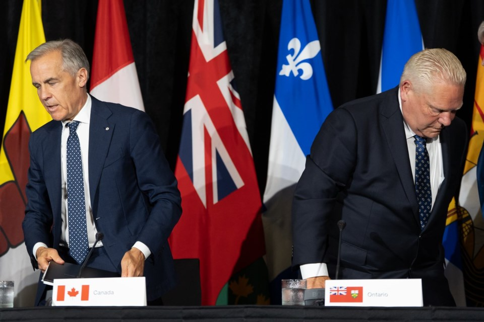 Prime Minister Mark Carney, left, and Ontario Premier Doug Ford leave the closing press conference at the First Ministers Meetings in Charlottetown on Thursday, July 23, 2026. THE CANADIAN PRESS/Darren Calabrese